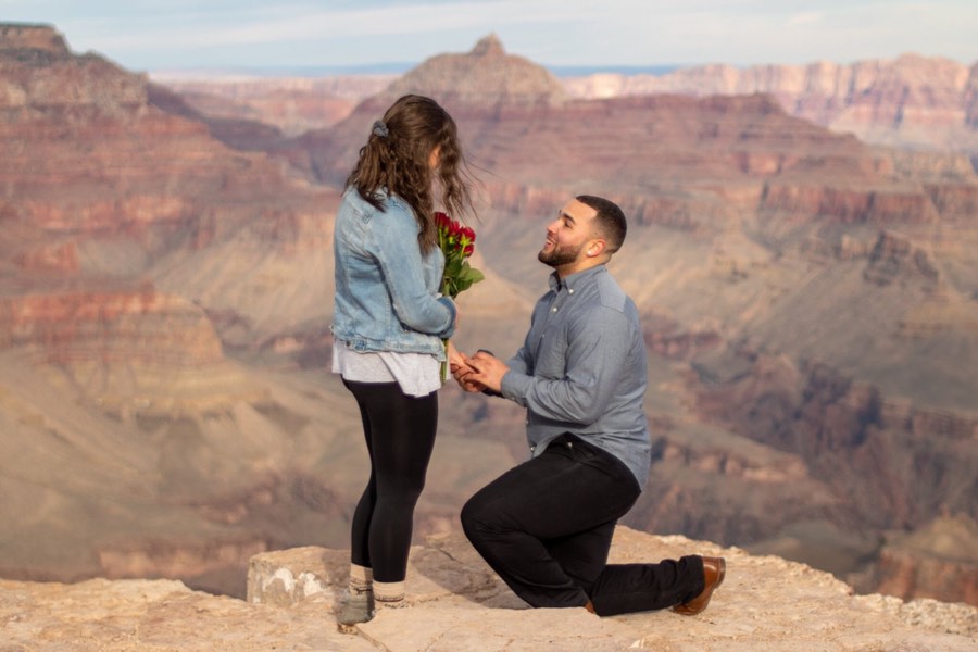 A proposal on one knee at the rim of the Grand Canyon