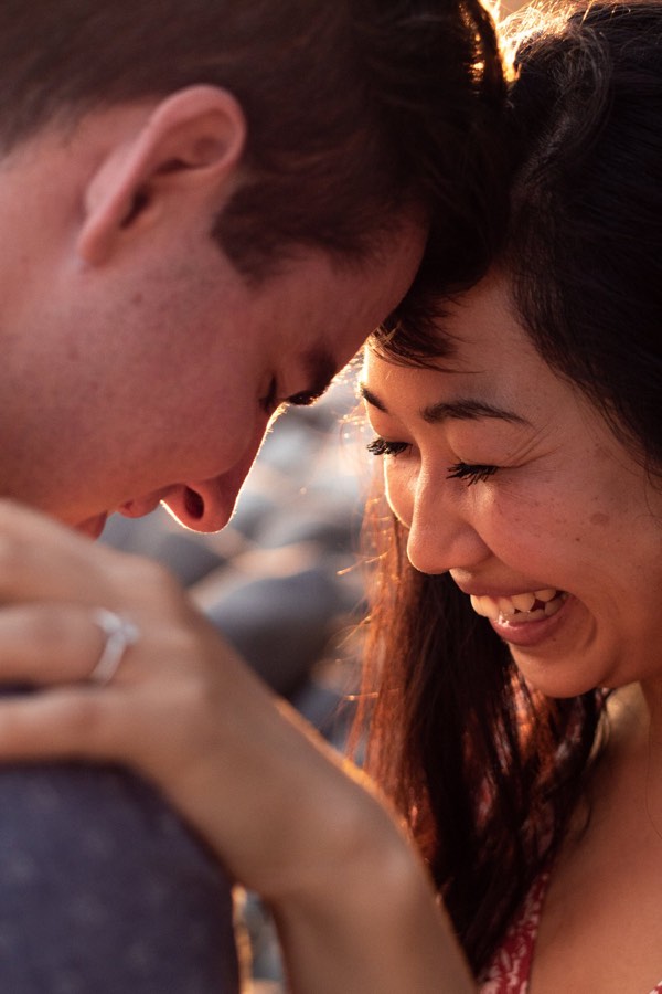 A couple laughing with their foreheads together