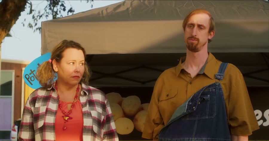 Tabitha and Leo standing at their roadside potato stand in Leo&rsquo;s Potatoes