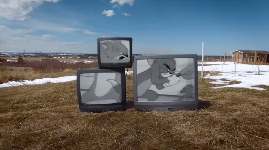 Three old televisions standing in a snowy field, from the We Don&rsquo;t Believe What&rsquo;s on TV music video